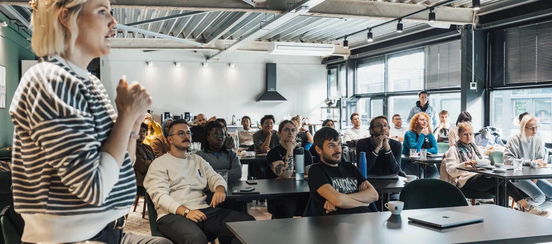 A speaker delivering a keynote to an engaged audience